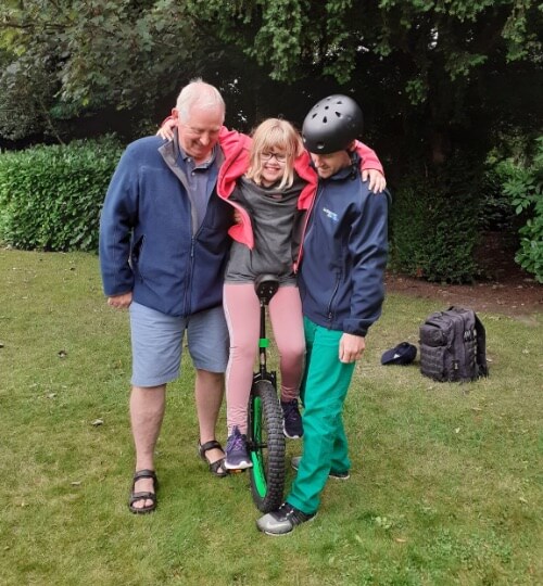 girl trying to ride a unicycle