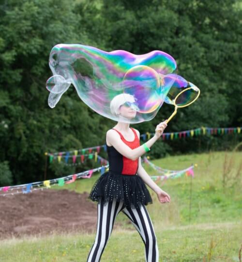 woman creating large bubbles