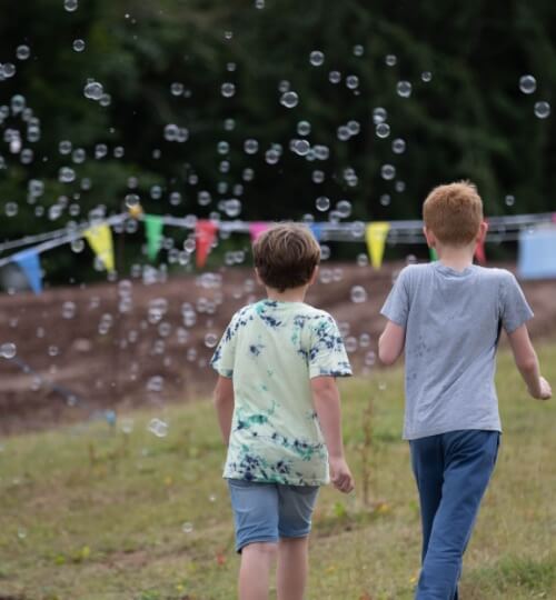 two children in front of bubbles