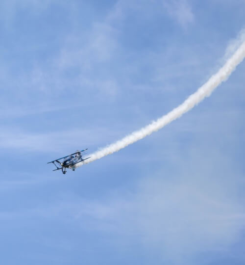 small plane flying on a sunny day